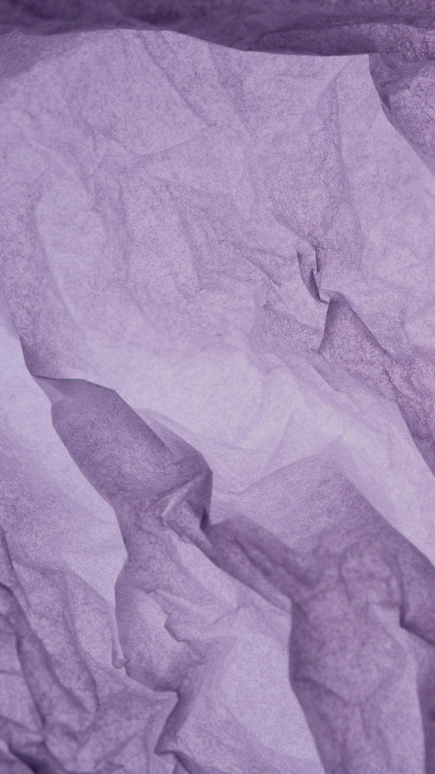 Abstract image of a crumpled purple paper, showcasing a unique texture for creative designs.